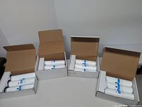 Four open cartons showing nine white AIC water filter cartridges