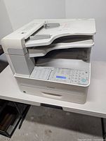 Front and right side view of Canon Laser Class 810 printer on table