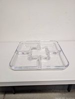 Top view of clear acrylic square tray showing five compartments