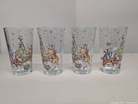Front view of four tumblers showing full character scene