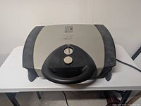 Top view of George Foreman Lean Mean Fat Grilling Machine electric contact grill showing handle and control knobs