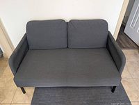 Front view of gray loveseat showing cushions, seat, and metal legs