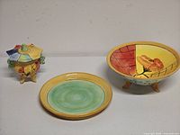 Set of three ceramic pieces – bowl, lidded jar, plate – top view
