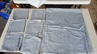 All eight gray pillow covers laid out, showing size comparison