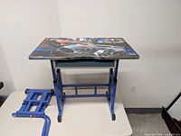 Full view of kids desk assembled with graphic top and blue frame