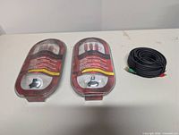 Front view of two sealed Rocketfish RCA cables and coiled speaker cable