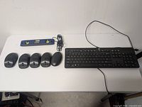 Group shot showing keyboard, five mice, level, cables