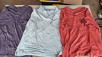 All three shirts laid flat showing colors and styles