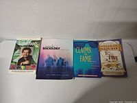 All four paperback books laid out side-by-side