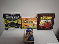 Front view of all four boxed games standing on table