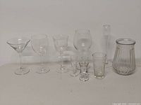 Front view of all ten clear glass pieces