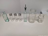 All seven glass containers lined up on table