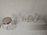 all six glass items lined on table