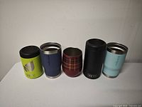 Group shot of five insulated stainless steel drinkware pieces