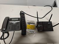 Router, surge protector, desk phone, sealed USB cable overview