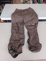 Full view of brown snowboard pants front