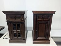 Front view of both nightstands showing drawers, doors, finish and outlets cord