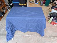 Blue flat sheet draped over table