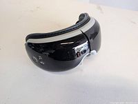Front view of Renpho eye massager showing glossy exterior and control buttons