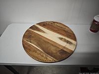 Full view of round wood board on table