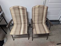Front view of two striped folding patio chairs