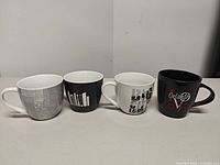 All four ceramic mugs side by side showing colours and designs