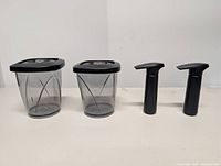 Front view of two containers with lids and two pumps