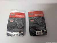 Front view of two sealed Valeo wrist support packages on table