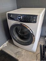 Front and left side view of washer showing door and cabinet