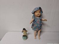 Wide shot of composition doll and porcelain figurine together