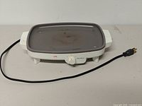 Front view of West Bend electric griddle showing cooking surface, control knob, power cord