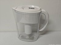 Side view of Brita pitcher showing transparent body, white lid and handle