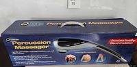 Front of retail box showing Quantum Percussion Massager branding
