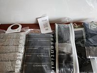 Overview of packaged grey Essentials briefs, Giordano briefs pack, zip-pouch briefs, lot tag