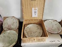 Overview of four Sakura plates and wicker box