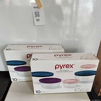 Front view of two sealed Pyrex glass storage set boxes