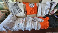 All 12 T-shirts displayed on couch