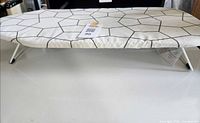 Top view of IKEA tabletop ironing board with hexagon cover