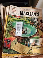 Stack of Maclean's magazines showing top issue with illustrated backyard pool cover