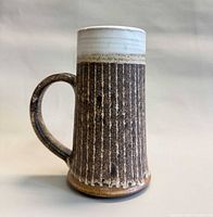 Side view showing full mug profile, glaze, and ribbed texture