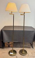 Front view of both brass floor lamps with shades