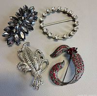 Group shot of the four rhinestone brooches
