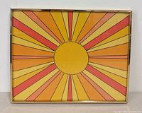 Front view of framed sunburst print with metal frame