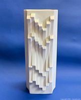 Front view of white geometric relief porcelain vase