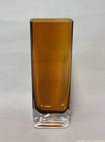 Front view of rectangular amber glass vase with clear base
