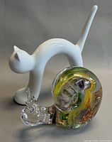 Porcelain cat and art glass snail together, front view