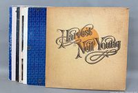 Front view of stacked albums showing Harvest by Neil Young and spines of additional records