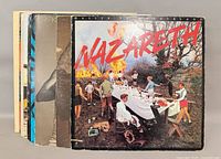 Stack of LPs fronted by Nazareth Malice in Wonderland; additional record spines visible