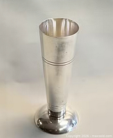 Full view of silver-plated vase standing upright