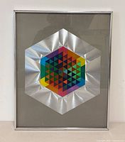Portrait view of framed foil artwork showing full design and frame